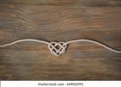 Heart Shaped Knot On Wooden Background