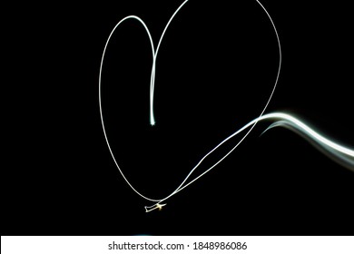 Heart Shaped Light Painting Made With Low Shutter Speed in the dark room - Powered by Shutterstock