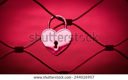 Heart shaped love padlock in Paris. Valentine's day background. Toned photo.
