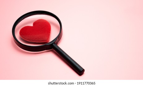 Heart shaped magnifying glass on pink background, Finding True Love Valentine concept. - Powered by Shutterstock