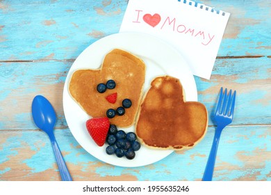Heart shaped pancakes with blueberry and strawberry. Breakfast for mom on mother's day