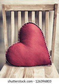 Heart Shaped Pillow On Wooden Chair With Vintage Look