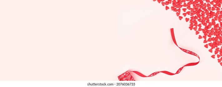 Heart Shaped Red Sprinkles Border And Gift Ribbon Roll, Festive Love Gift And Valentine's Day Concept Or Wedding Day. Wide Banner. Small Hearts. Selective Focus