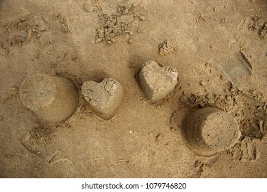 Heart Shaped Sand Castel On Beach