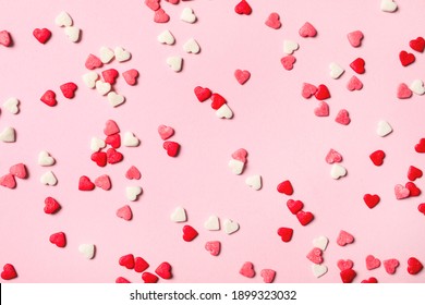 Heart shaped sprinkles on pink background, flat lay - Powered by Shutterstock