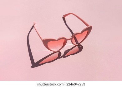 Heart shaped sunglasses on the pink background. Valentine's day concept composition	 - Shutterstock ID 2246047253