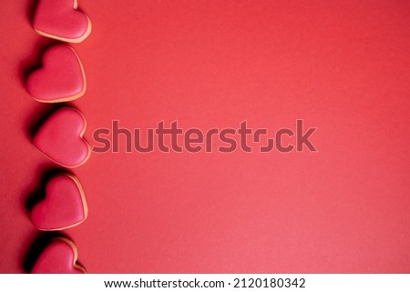 heart shaped valentine cookies on the red brown background