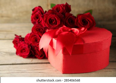 Heart Shaped Valentines Day Gift Box With Red Roses On Old Wooden Table