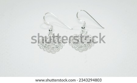 Heart silver earrings display on white background