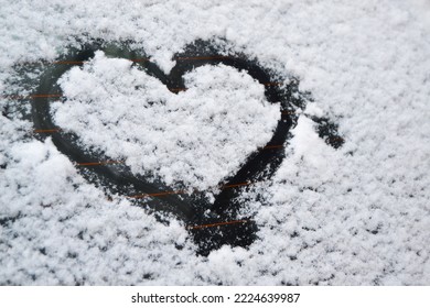 Heart In The Snow On The Windshield Of A Car