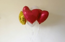 Heart And Star Shaped Balloons For Valentines Day On Light Brown Pastel Background Close Up