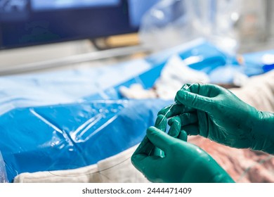 Heart stent placement process in operating room. Heart doctor inserting central venous catheter, Jugular venous catheterization. A central venous catheter is inserted into the jugular vena.