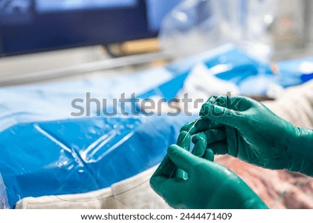 Heart stent placement process in operating room. Heart doctor inserting central venous catheter, Jugular venous catheterization. A central venous catheter is inserted into the jugular vena.