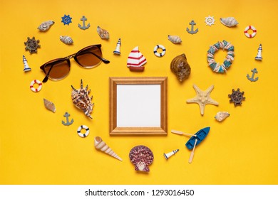 Heart Symbol Made Of Decorative Items, Miniature Toys And Beach Accessories: Seashells, Sunglasses, Bracelet, Vessel, Life Buoys. Empty Wooden Photoframe, Mock Up. Summer Vacation, Sea Travel Concept