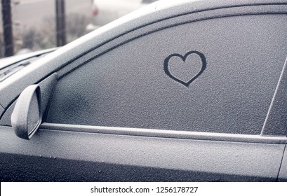 Heart Symbol On Frozen Car Window In Winter