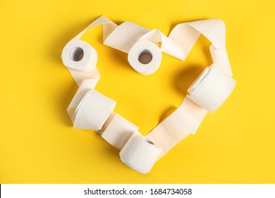 Heart Of Toilet Paper Rolls On Yellow Background