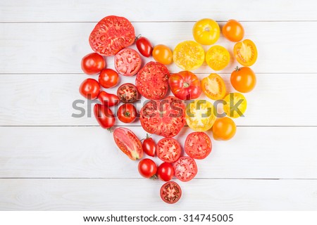 Heart from tomatoes, on a white rusric board