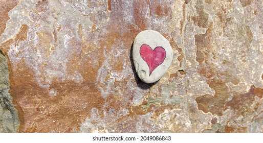 Heart written in stone on a granite background. Love, relationships, impressions.