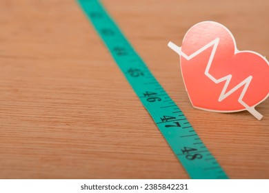 Heartbeat rate symbol and measuring tape. keeping track of your heart rate provides you with real-time data so you can adjust your output to suit your fitness goals - Powered by Shutterstock