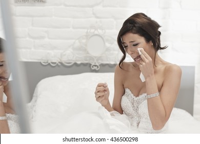 Heart-broken bride holding engagement ring, crying on wedding-day. - Powered by Shutterstock