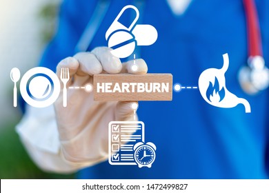 Heartburn Acid Reflux Disease Stomach Symptoms Health Care Concept. Doctor Hold Wooden Block With Heartburn Word And Arround Gastric Icons.