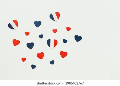 Hearts in the colors of the French flag on a light background, 14 July Bastille Day and French National Holiday, top view