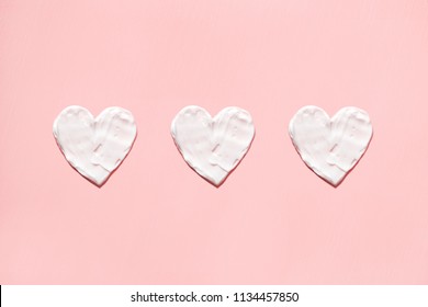 Hearts From Cream In Pink Background. Skin Care.