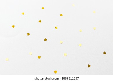 hearts made of golden glitter and stars on a pink background. Valentines day, love concept.Gold hearts texture. Golden valentine day background.