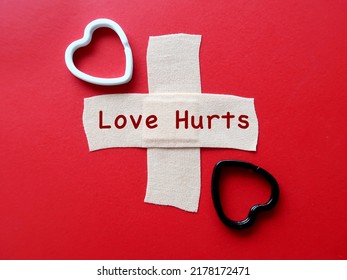 Hearts On Band Aid Plaster With Handwritten Text LOVE HURTS, Concept Of Healing A Broken Heart, Fix A Wounded Painful Heartbreak