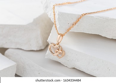 Hearts shape rose gold pendant necklace on white background. Romantic  jewelry. Advertising still life product concept for Valentines Day - Shutterstock ID 1634334484