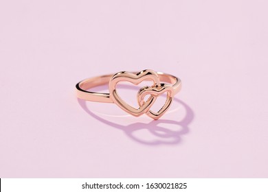 Hearts Shape Rose Gold Ring On Pink Background. Romantic  Jewelry. Advertising Still Life Product Concept For Valentines Day