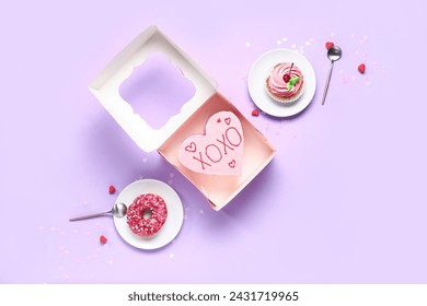 Heart-shaped bento cake with donut and cupcake on purple background. Valentine's Day celebration - Powered by Shutterstock