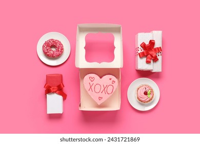 Heart-shaped bento cake with gift boxes, cupcake and donut on pink background. Valentine's Day celebration - Powered by Shutterstock