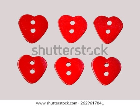 Heart-shaped buttons isolated  for design. Symbol of love. Red buttons frame on fabric texture background. 	
