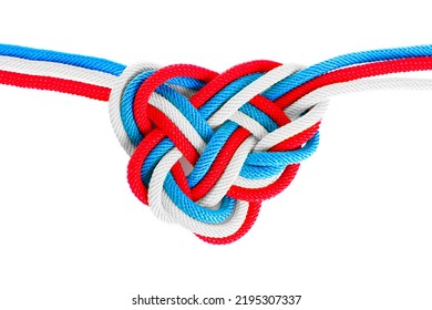 Heart-shaped Celtic Knot Made From Braided Cords Dyed White, Blue And Red, Isolated On White Background. Creative Loyalty And Faith Concept.