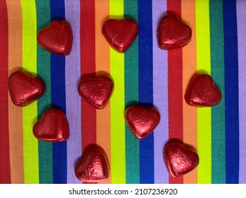 Heart-shaped chocolates placed on a rainbow background; LGBT, Valentine's Day, White Day, love concept.