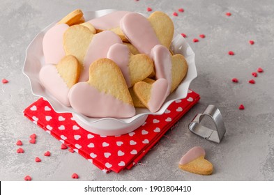 Heart-shaped cookies with pink chocolate glaze for Valentine's Day on a white stand on the gray background. Valentine's Day food background - Powered by Shutterstock