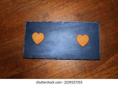 heart-shaped gingerbread cookies on a dark background