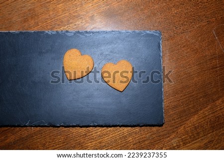 heart-shaped gingerbread cookies on a dark background
