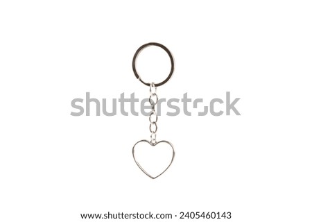 Heart-shaped keychain with key ring isolated on white background. Concepts for real estate and moving home or renting property. Buying a property. Mock-up keychain.Copy space.