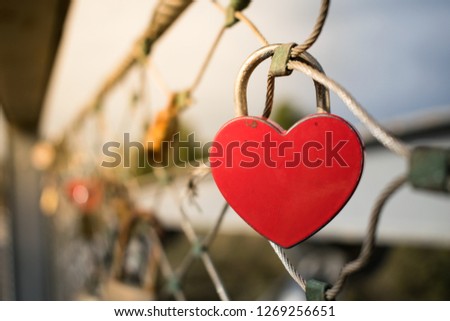 Heart-shaped love lock hanging on a bridge in Tel Aviv, Israel. Valentine's Day background.