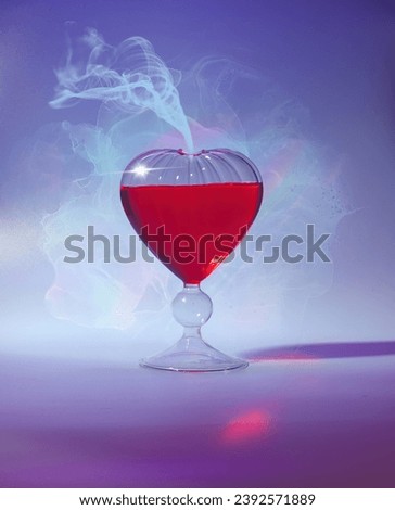 Heart-Shaped Love Potion in Glass Flacon for Romantic Valentine's Day Celebration - Bright and Cheerful Close-Up Shot with Vivid Red and Blue Hues