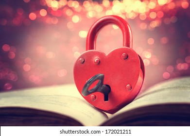 Heart-shaped Padlock With Key On Open Book