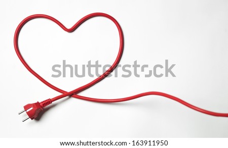 Heartshaped red cable on white background