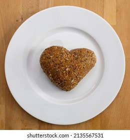 Heart-shaped Whole Wheat Bun On White Plate