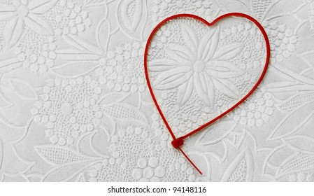 Heart-shaped Zip Tie On A Patterned Background