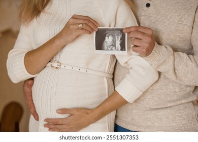 Heartwarming Expectant Parents Holding Ultrasound Image in Cozy Setting. - Powered by Shutterstock