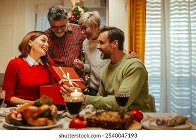 Heartwarming family dinner during christmas, filled with joy and love, decorations, gifts, and laughter, capturing the holiday spirit of togetherness - Powered by Shutterstock