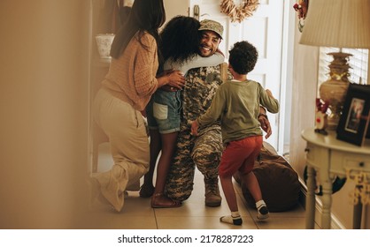 Heartwarming military homecoming. Happy soldier reuniting with his wife and children after serving in the army. Cheerful serviceman embracing his family after returning home from deployment. - Powered by Shutterstock