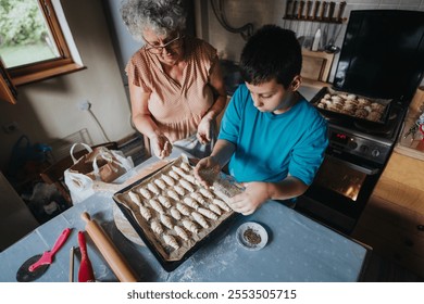 A heartwarming moment of a grandmother teaching her grandson to bake pastries in a cozy kitchen setting. They are preparing dough on a baking tray, fostering family bonding and culinary skills. - Powered by Shutterstock